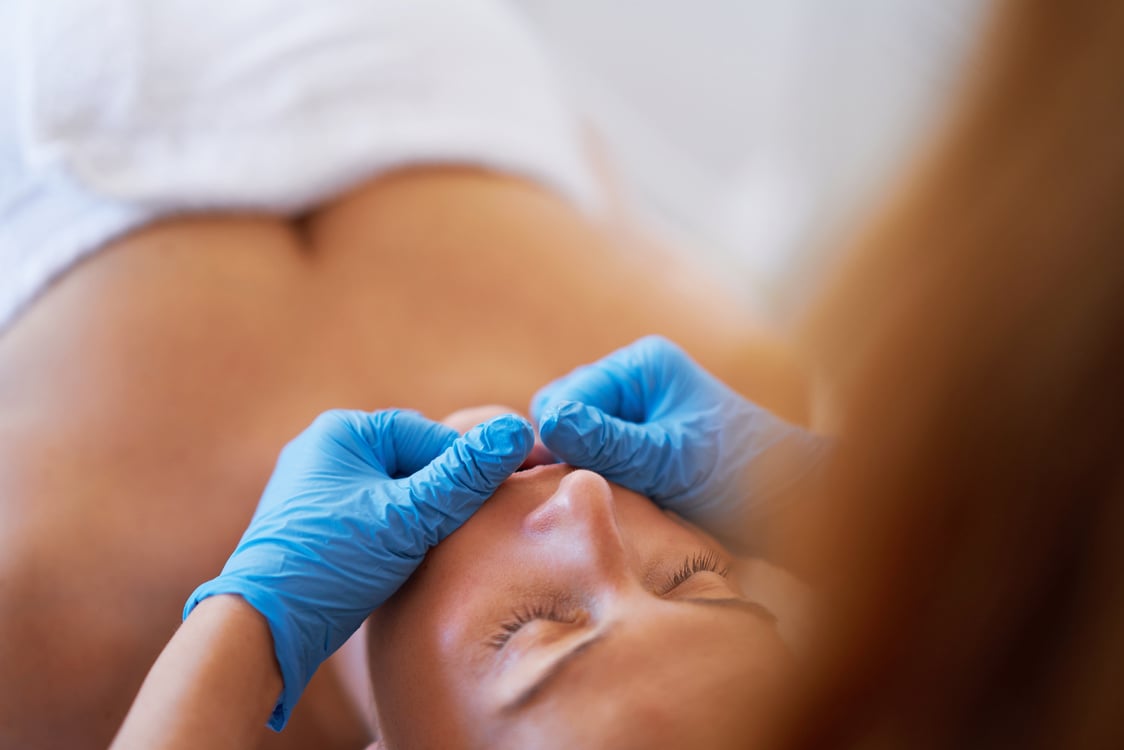 Woman Having Mouth Massage in Blue Gloves